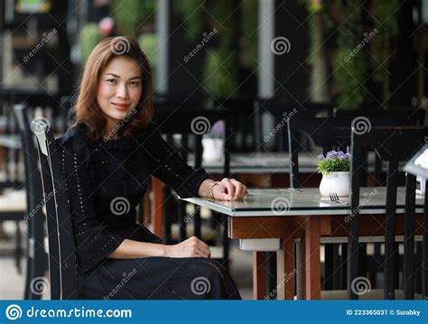 Beautiful Cute Asian Woman In Black Dress Sitting Alone In Outdoor Food