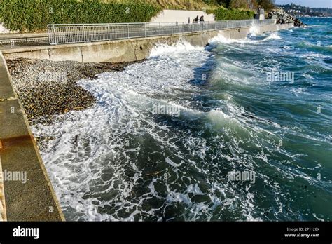 Wind Blows Waves Into The Sea Wall In West Seattle Washingon Stock