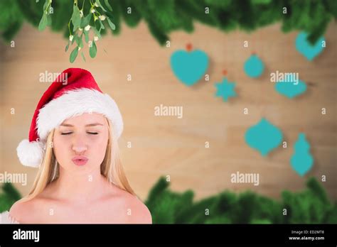 Composite Image Of Festive Cute Blonde Under Mistletoe Stock Photo Alamy