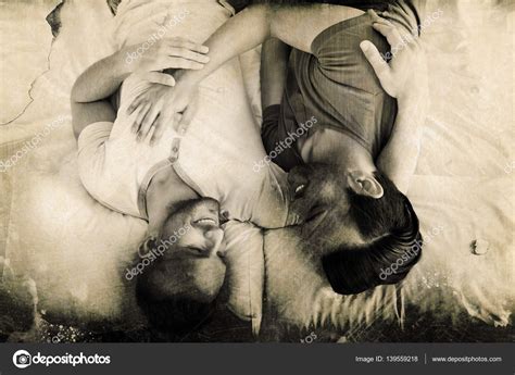 Gay Couple Lying On Bed Stock Photo Wavebreakmedia