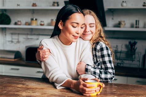 Free Photo Lesbian Couple Embracing In Kitchen