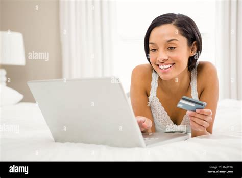 Smiling Brunette Using Laptop And Holding Credit Card Stock Photo Alamy