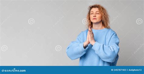 Grateful Hopeful Middle Age Woman Stands In Meditative Pose Enjoys