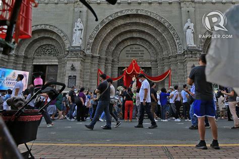 Catholic Devotees Line Up In Front Of The Manila Cathedral To Celebrate