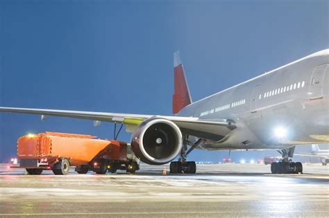 Premium Photo Airfield Tanker Refuels A Widebody Passenger Aircraft