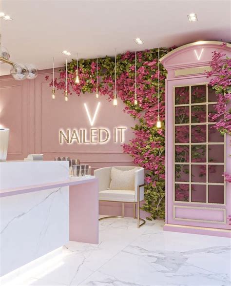 The Interior Of A Nail Salon With Pink Flowers On The Wall