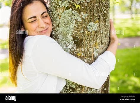 Beautiful Brunette Hugging A Tree Stock Photo Alamy