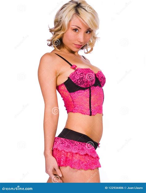 A Blonde Wearing Pink And Black Lingerie Pose Together Against A White Backdrop Stock Photo