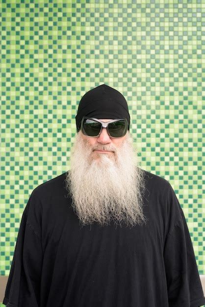 Premium Photo Portrait Of Man Wearing Sunglasses Standing Against Wall