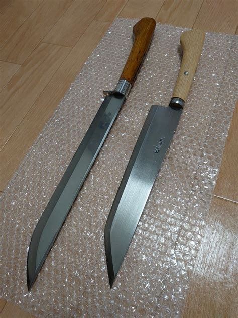 Two Knives Sitting On Top Of A Table Next To Each Other