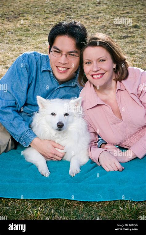 Young Married Couple Asian Man With Glasses And Pregnant Caucasian