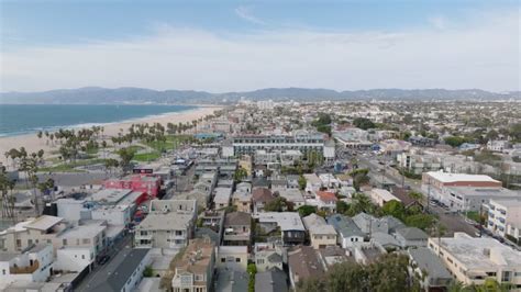 Aerial Footage Of Urban Neighbourhood And Sand Beach On Ocean Coast