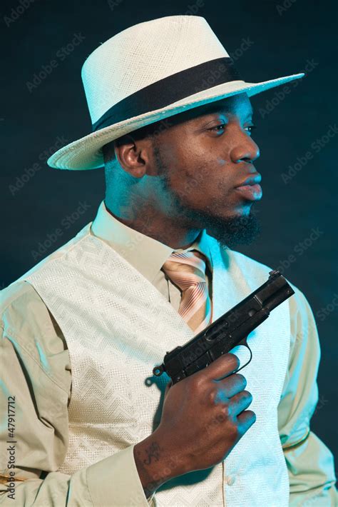 Black american mafia gangster man in suit with pistol. Stock Photo ...