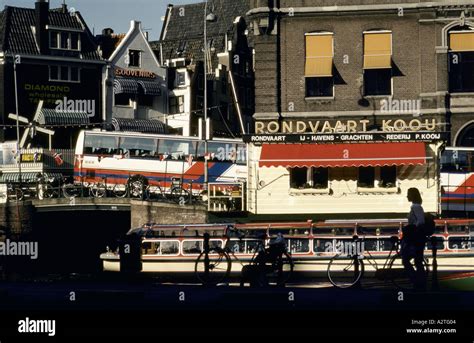 amsterdam canal boat and tourist buses in amsterdam Stock Photo - Alamy