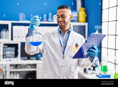 African American Man Scientist Holding Test Tube Reading Document At