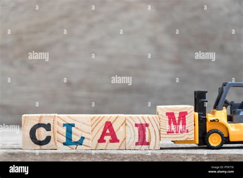 Toy Forklift Hold Letter Block M To Complete Word Claim On Wood