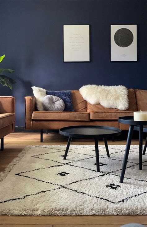 A Living Room With Two Couches Coffee Table And Rugs On The Floor