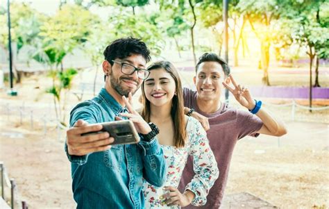 Premium Photo Happy Friends Taking A Selfie In A Park Three Friends