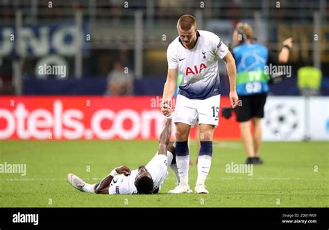 Tottenham Hotspurs Eric Dier Right Helps Up Team Mate Serge Aurier