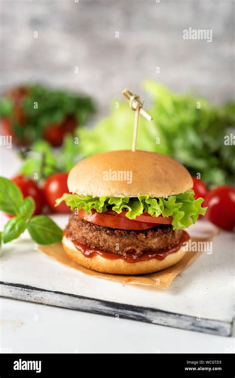 Homemade vegan burger on white rustic background Stock Photo - Alamy