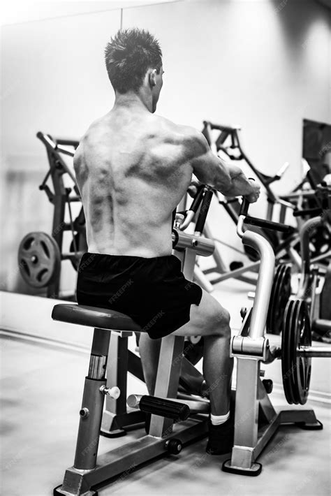 Premium Photo Strong Muscular Bodybuilder Man Doing Back With The