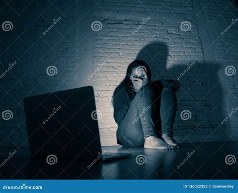 Woman Suffering Internet Cyber Bullying And Harassment Feeling Lonely Looking Afraid At Laptop