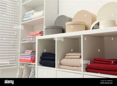 Different Colorful Bed Linens And Decorative Boxes On Display In Home