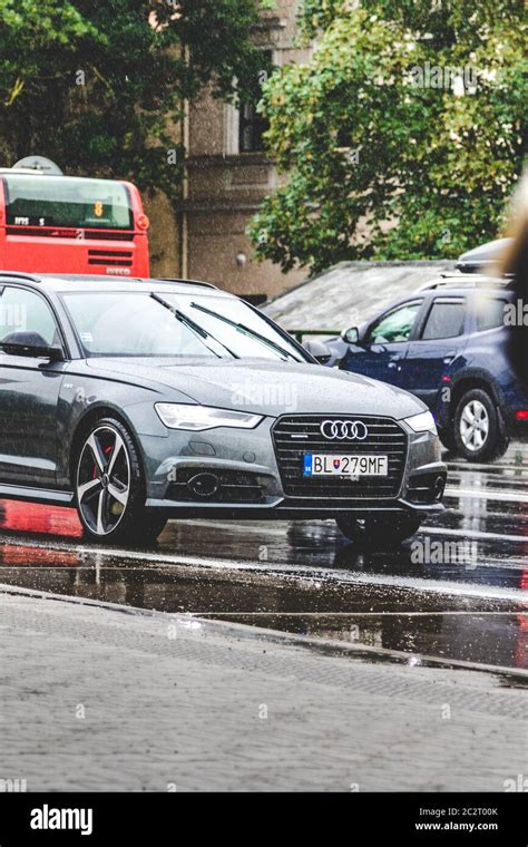 Expensive Modern Grey Car On Street Road At Rainy Moody Cloudy Day