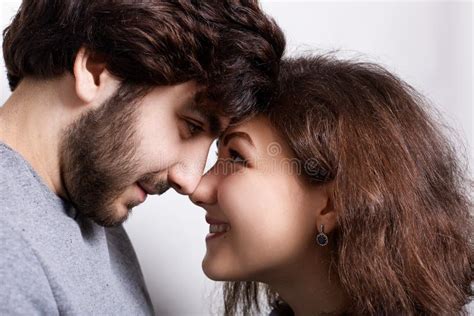 Happy Couple In Love Touching Noses Smiling And Looking At Each Other`s