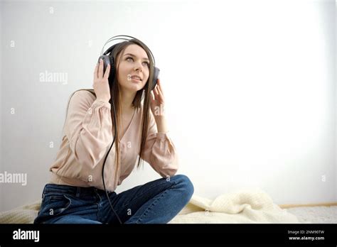 Attractive Cheerful Brunette Woman Listening And Enjoying Music In Headphones Smiling Laughing