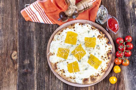 Four Types of Cheese Italian Pizza on a Wooden Floor Stock Image ...