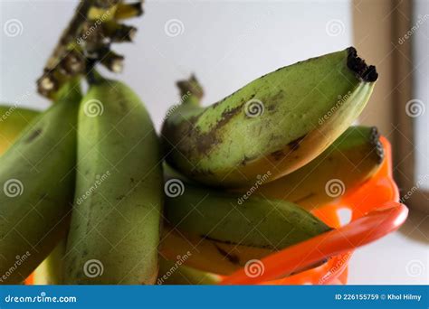 Bunch of Fresh Green Ambon Bananas in a Fruit Basket Isolated on a Blue ...