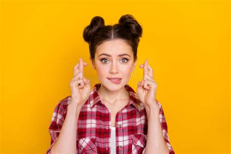 Portrait Of Pretty Worried Lady Biting Lip Crossed Fingers Look Camera Isolated On Yellow Color