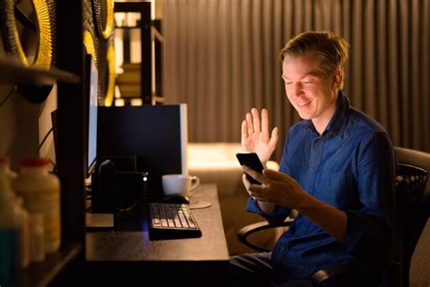 Premium Photo Man Using Mobile Phone While Sitting On Table