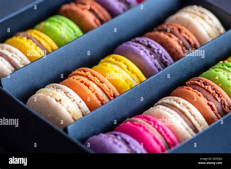 Various Colorful Macarons Or French Macaroons In A Row In A Gift Box