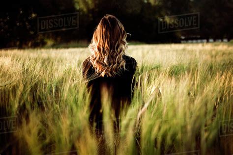 Caucasian Woman Standing In Tall Grass Stock Photo Dissolve