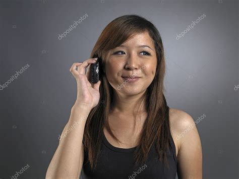 Asian Chinese Girl Answering Her Phone — Stock Photo © Jacetan 6545669