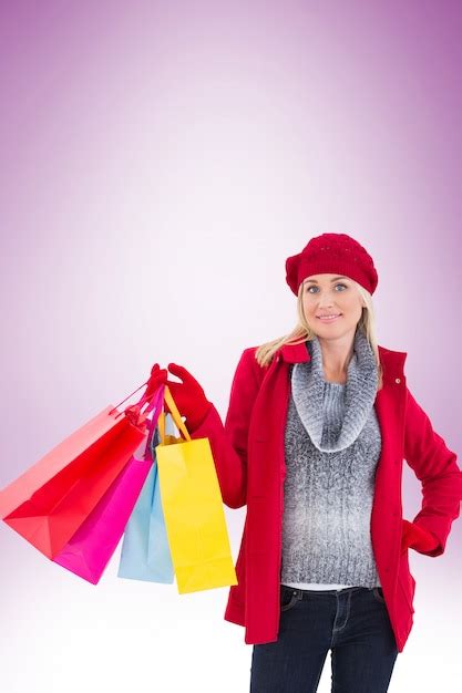 Premium Photo Blonde In Winter Clothes Holding Shopping Bags