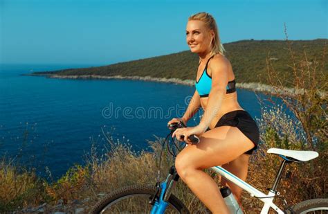 Woman Cyclist on a Mountain Bike Looking at the Landscape of Mountains ...