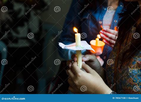 Closeup Of People Holding Candle Vigil In Dark Seeking Hope Stock Photo