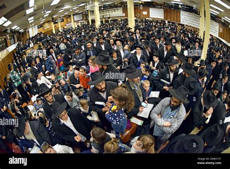 A large crowd of orthodox Jewish men & children gather in the main ...