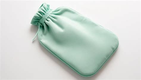 Premium Photo Green Or Mint Hot Water Bottle Or Bag For Relieving Menstrual Pain With Copy Space