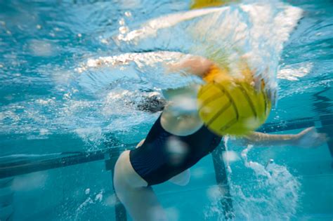 Professional Female Water Polo Player Dribbling The Ball Stock Photo