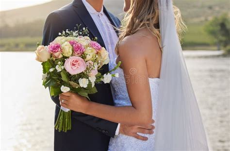 Flower Bouquet Wedding And Hug With Couple In Nature For Commitment