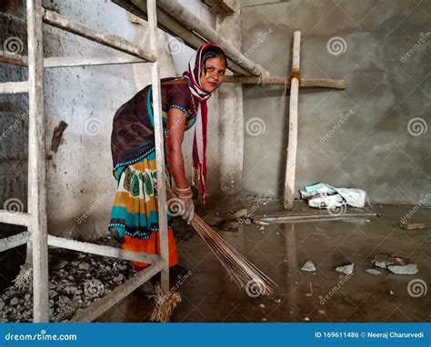 An Indian Village Lady Labour Cleaning Floor At Construction Site In