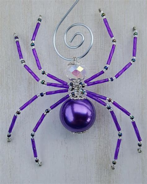 A Handmade Beaded Spider Ornament Made With An XL Purple Pearl Bubble