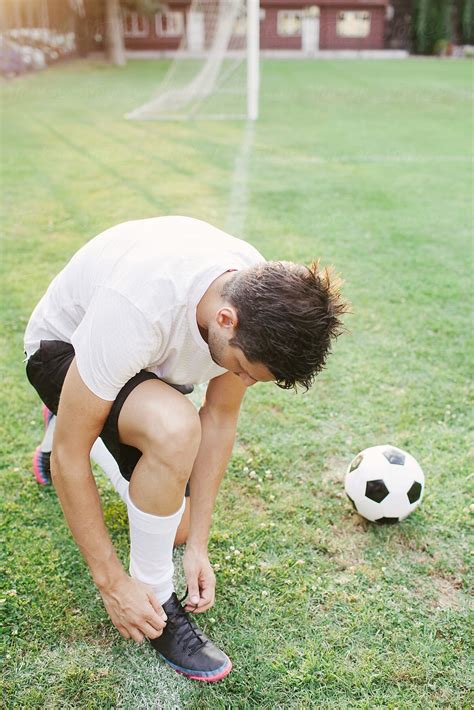 Football Player Tying His Soccer Sneakers By Stocksy Contributor Ani