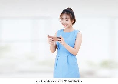 Smiling Charming Brunette Asian Woman Uses Stock Photo