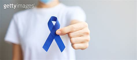 March Colorectal Cancer Awareness Month Woman Holding Dark Blue Ribbon