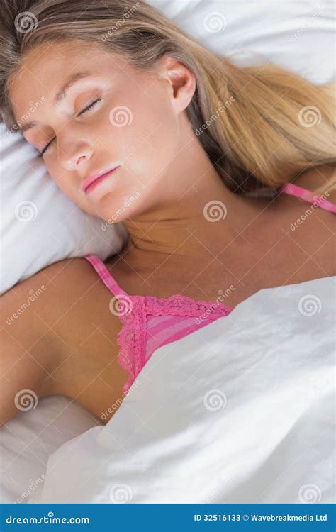 Peaceful Blonde Lying On Her Bed Asleep Stock Image CartoonDealer